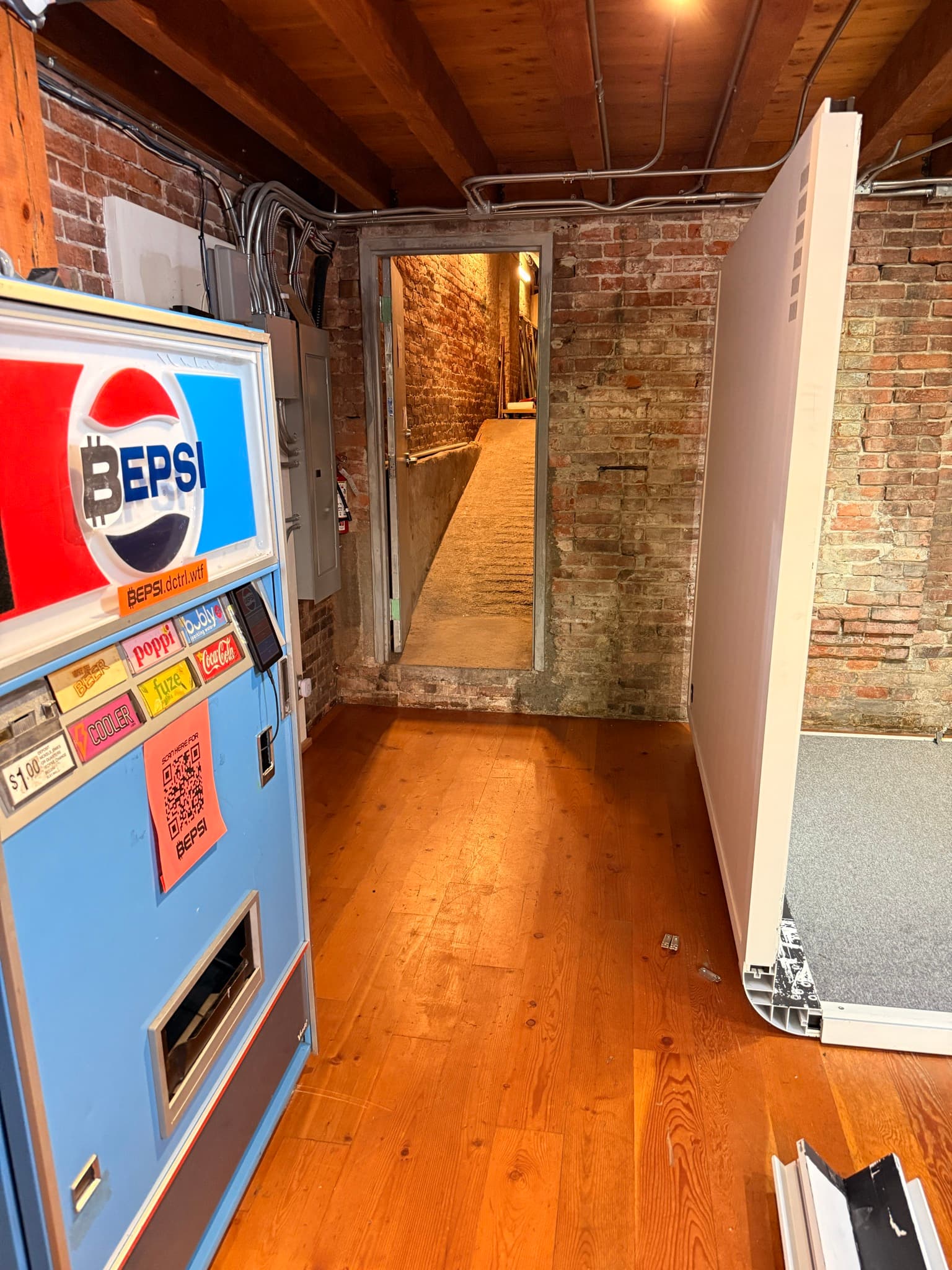 The DCTRL space — a bitcoin-branded BEPSI machine against exposed brick